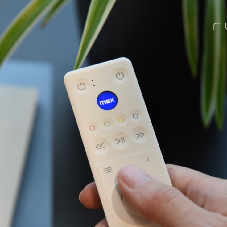 The remote control features a programmable touch-sensitive LCD button